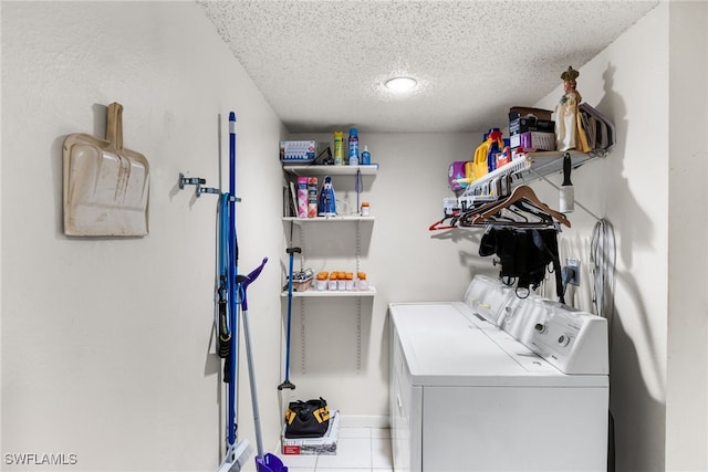 laundry room with a textured ceiling, laundry area, and separate washer and dryer