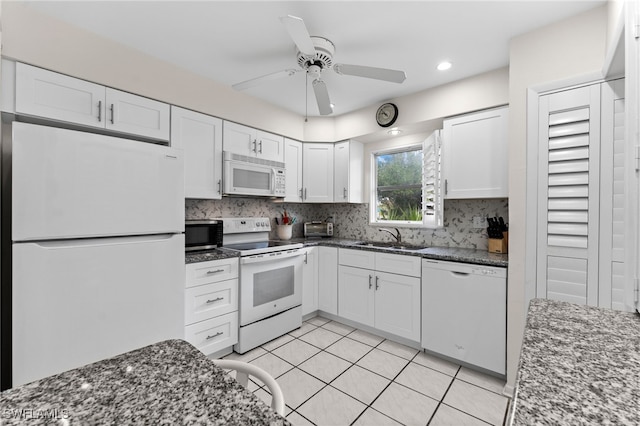 1050 Lake Mcgregor Dr Unit 6747, Fort Myers, FL 33919 - kitchen featuring white appliances, white cabinetry, a sink, and dark stone countertops