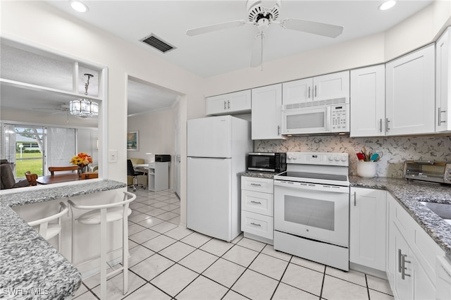 1050 Lake Mcgregor Dr Unit 6747, Fort Myers, FL 33919 - kitchen featuring white appliances, white cabinetry, visible vents, and a ceiling fan