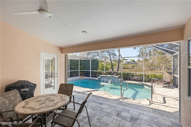 pool with ceiling fan, glass enclosure, and a patio area