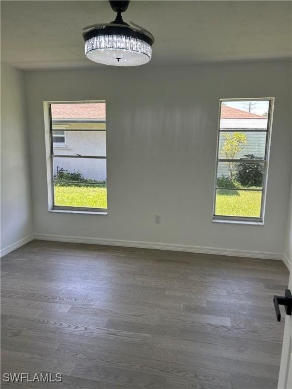 empty room with dark hardwood / wood-style flooring