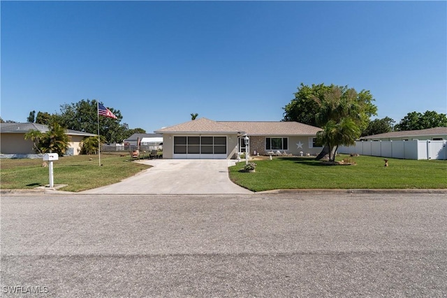 ranch-style home featuring a front lawn and a garage