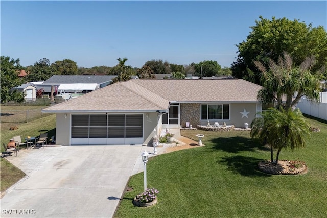 ranch-style home featuring a garage and a front lawn