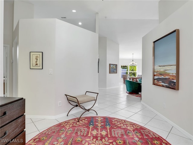 hallway with recessed lighting, visible vents, light tile patterned flooring, a chandelier, and baseboards