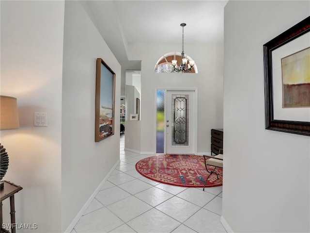 foyer with light tile patterned floors, baseboards, and a chandelier