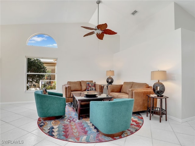 living area featuring high vaulted ceiling, visible vents, baseboards, and light tile patterned flooring