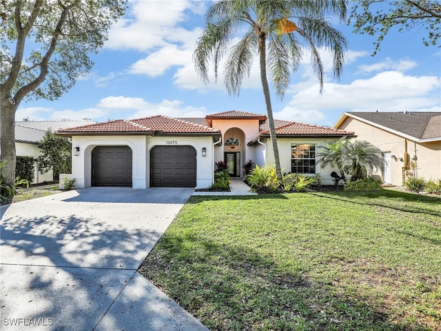 mediterranean / spanish home featuring a garage, a front yard, concrete driveway, and a tile roof