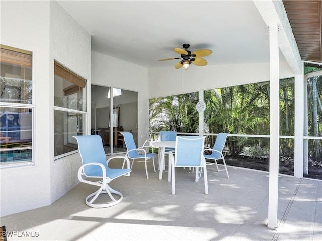 sunroom with a ceiling fan