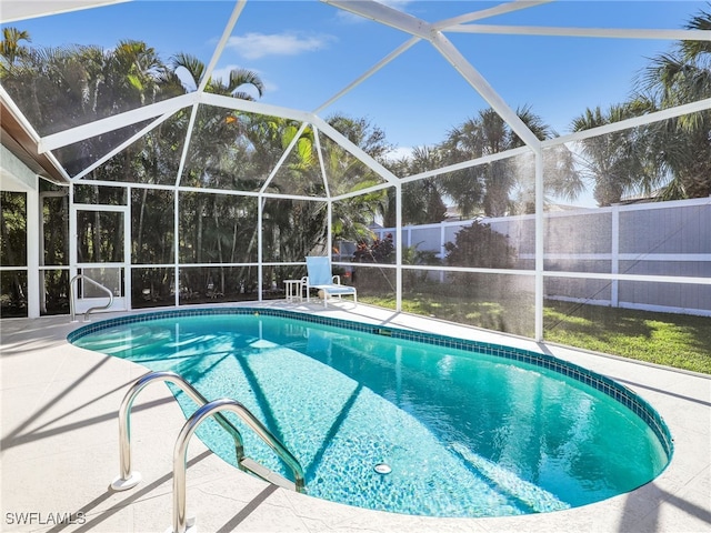 pool with a fenced backyard and a lanai