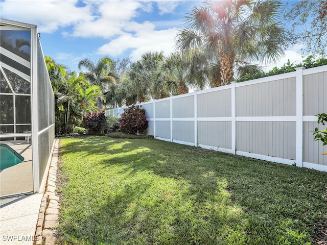 view of yard featuring a fenced in pool, a lanai, and a fenced backyard