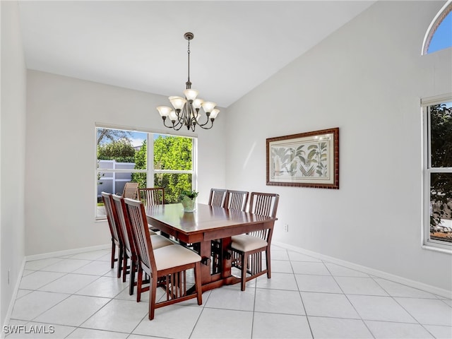 dining area with an inviting chandelier, light tile patterned floors, baseboards, and vaulted ceiling