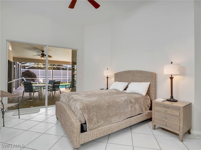 bedroom featuring a ceiling fan, access to outside, a sunroom, and light tile patterned floors