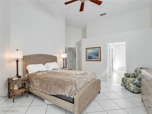 bedroom featuring light tile patterned floors, visible vents, baseboards, ensuite bath, and ceiling fan