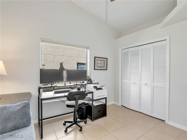 office with lofted ceiling, light tile patterned flooring, and baseboards