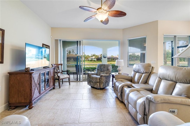10644 Pelican Preserve Blvd Unit 102, Fort Myers, FL 33913 - living room featuring ceiling fan, stone tile flooring, and baseboards