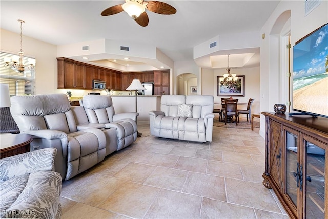 10644 Pelican Preserve Blvd Unit 102, Fort Myers, FL 33913 - living area with a chandelier, arched walkways, a ceiling fan, a raised ceiling, and recessed lighting