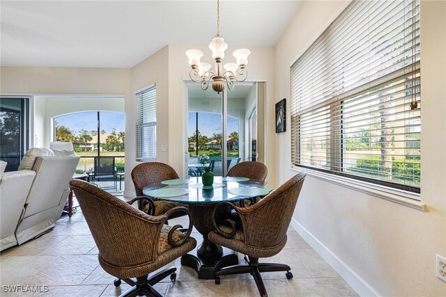 10644 Pelican Preserve Blvd Unit 102, Fort Myers, FL 33913 - dining area featuring a chandelier, baseboards, and light tile patterned floors