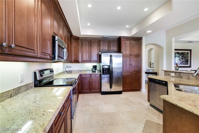 10644 Pelican Preserve Blvd Unit 102, Fort Myers, FL 33913 - kitchen with appliances with stainless steel finishes, a sink, light stone countertops, recessed lighting, and arched walkways