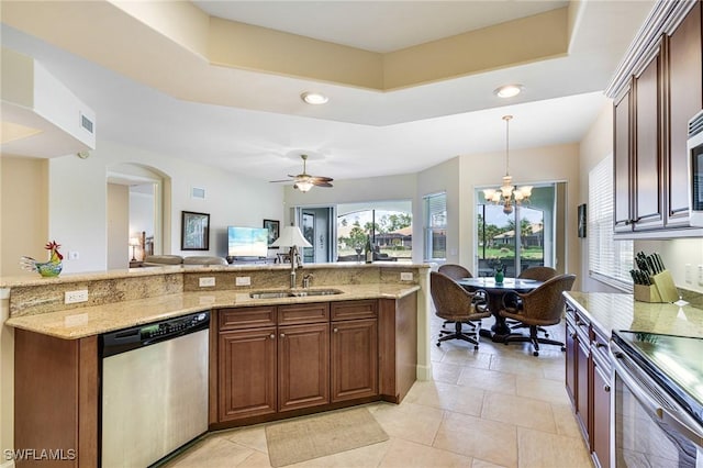 10644 Pelican Preserve Blvd Unit 102, Fort Myers, FL 33913 - kitchen featuring stainless steel appliances, a sink, a raised ceiling, light stone counters, and recessed lighting