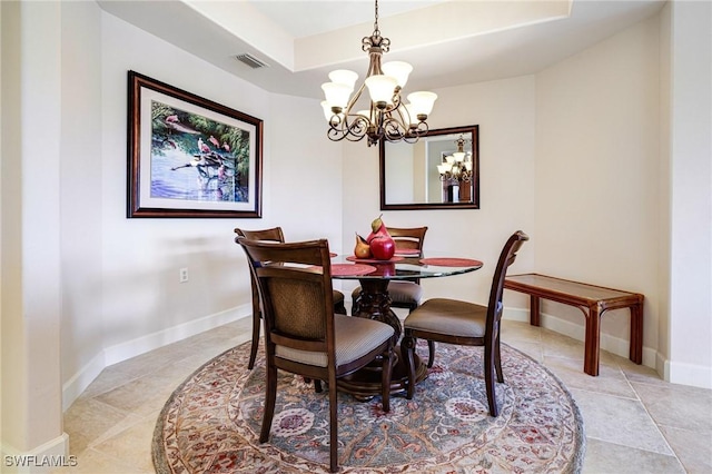 10644 Pelican Preserve Blvd Unit 102, Fort Myers, FL 33913 - dining space with a chandelier, light tile patterned floors, a tray ceiling, and baseboards