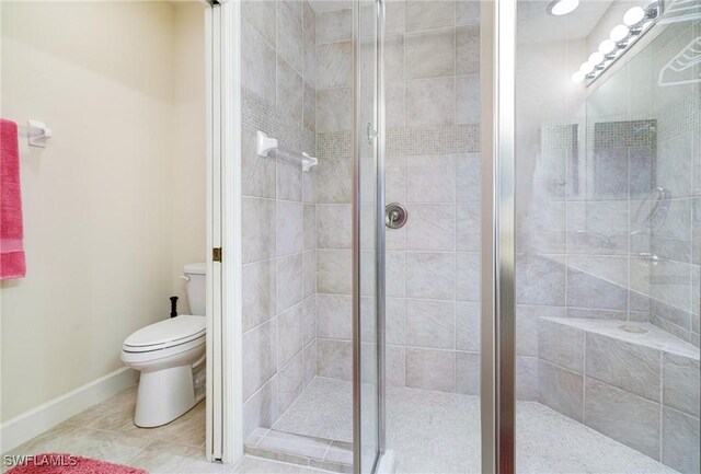10644 Pelican Preserve Blvd Unit 102, Fort Myers, FL 33913 - bathroom with toilet, a shower stall, tile patterned flooring, and baseboards