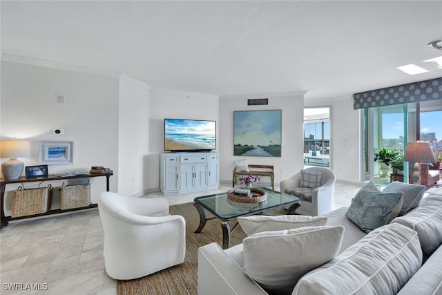 living area with stone finish flooring, ornamental molding, visible vents, and baseboards