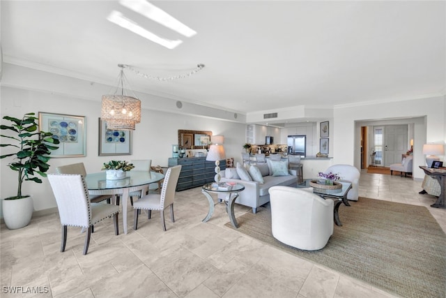 living room featuring visible vents, a chandelier, and crown molding