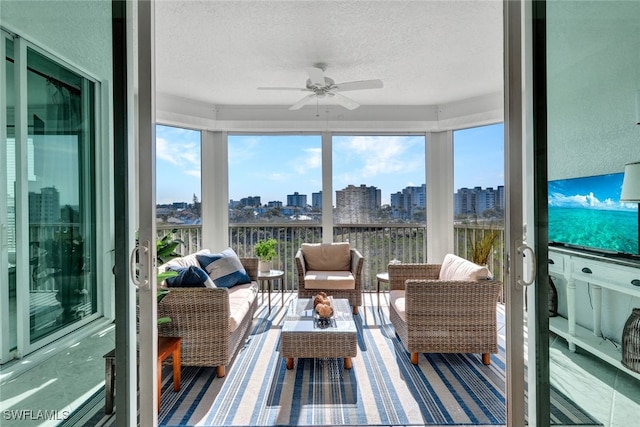 sunroom featuring ceiling fan