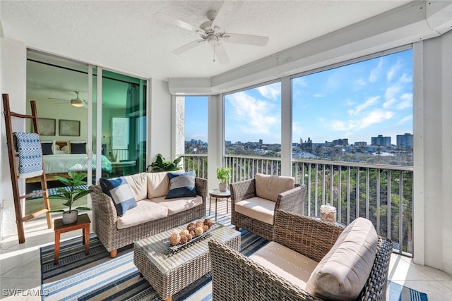 sunroom featuring a city view and ceiling fan