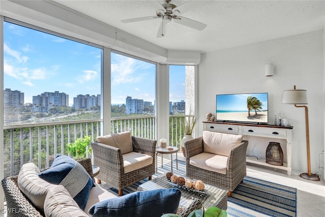 sunroom / solarium featuring a view of city and ceiling fan