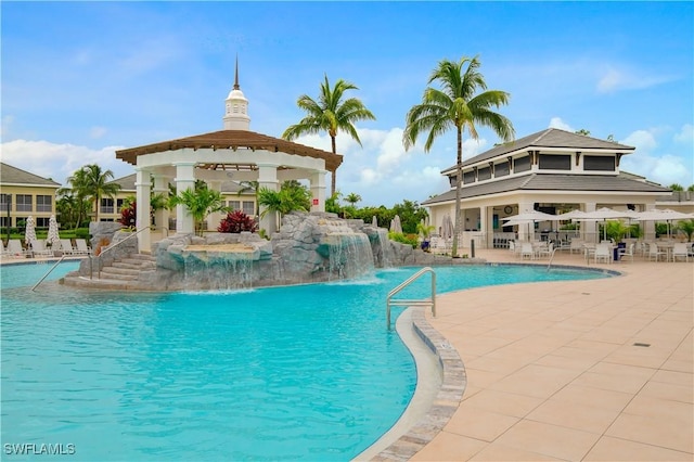 community pool with fence, a patio, and a gazebo