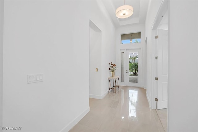 entryway featuring light tile patterned floors and baseboards