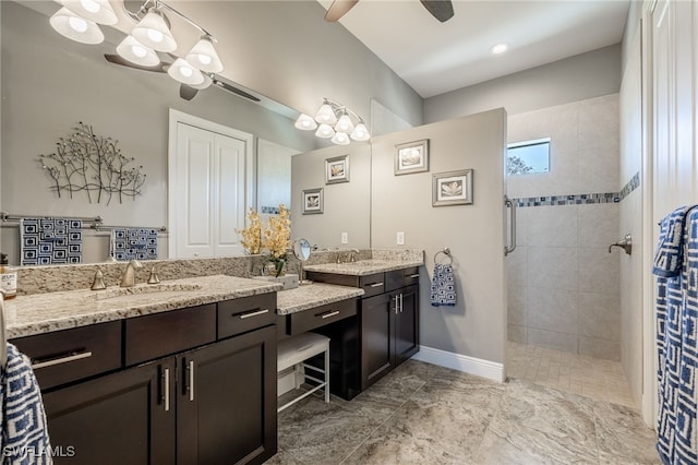 bathroom with ceiling fan, walk in shower, vanity, and baseboards