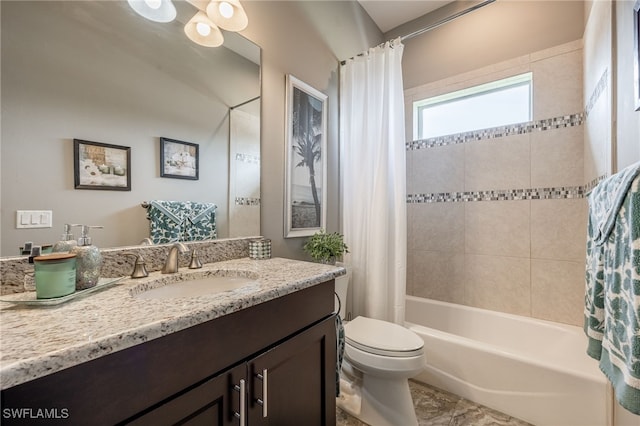 bathroom with vanity, shower / bath combo with shower curtain, and toilet