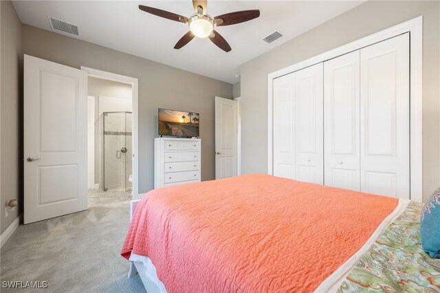 bedroom featuring light colored carpet, a closet, visible vents, and ensuite bath