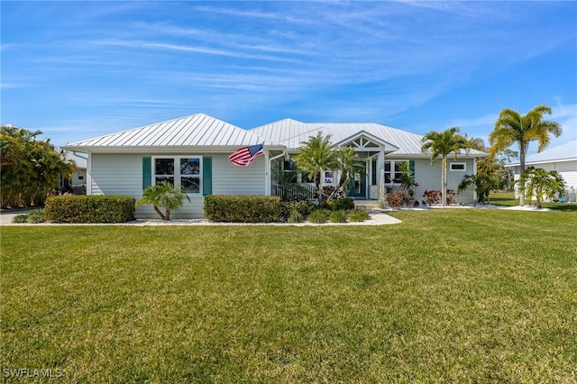 ranch-style house with metal roof and a front lawn