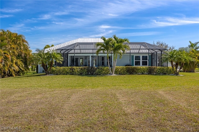 back of house featuring a yard and a lanai