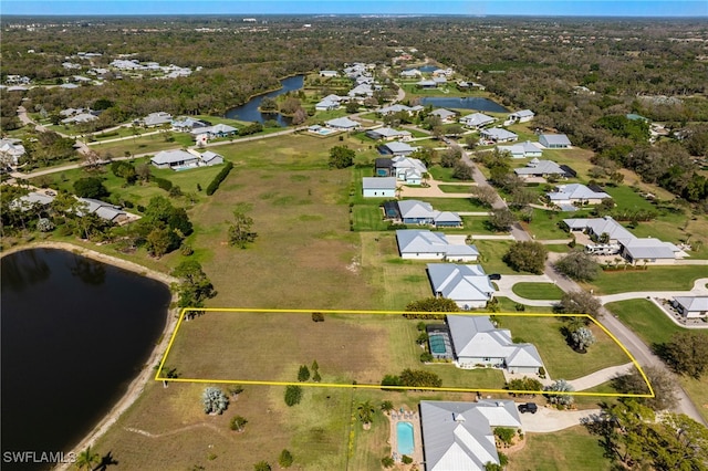 bird's eye view with a water view and a residential view
