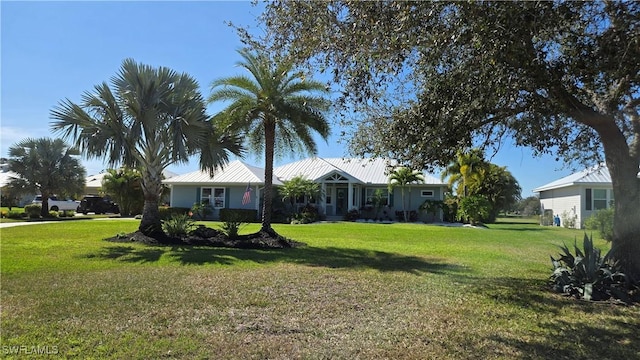 single story home with metal roof and a front lawn