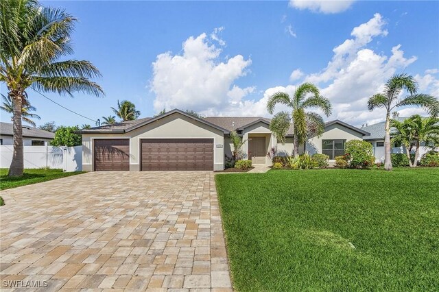 ranch-style house featuring a front yard and a garage