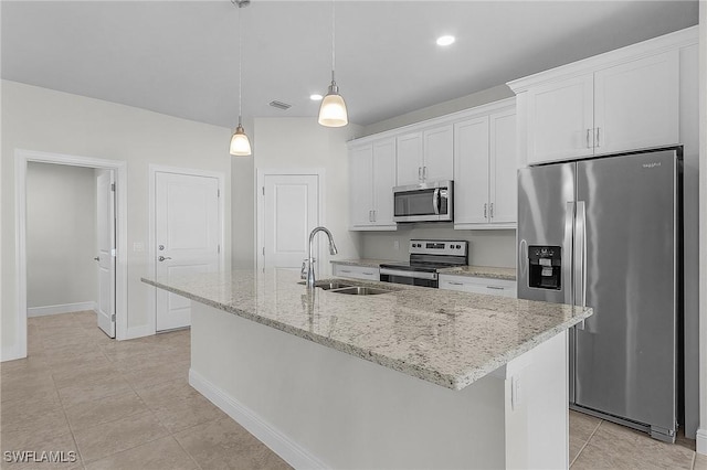 1729 SW 22nd Ter, Cape Coral, FL 33991 - kitchen with appliances with stainless steel finishes, sink, white cabinetry, pendant lighting, and a kitchen island with sink