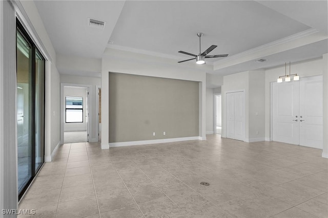 1729 SW 22nd Ter, Cape Coral, FL 33991 - tiled empty room with a raised ceiling, crown molding, and ceiling fan
