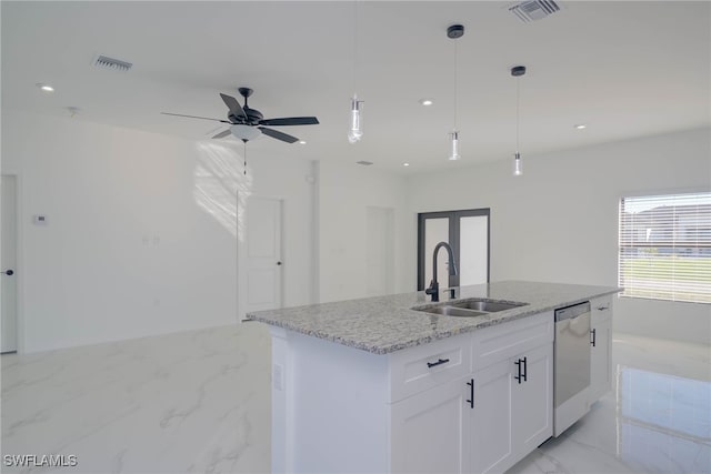 kitchen featuring a kitchen island with sink, light stone countertops, sink, stainless steel dishwasher, and white cabinets