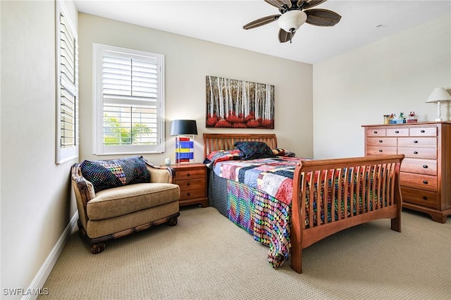 carpeted bedroom with baseboards and a ceiling fan