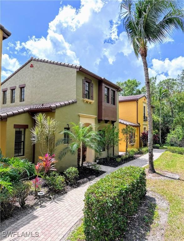 view of front of property featuring stucco siding and a tile roof