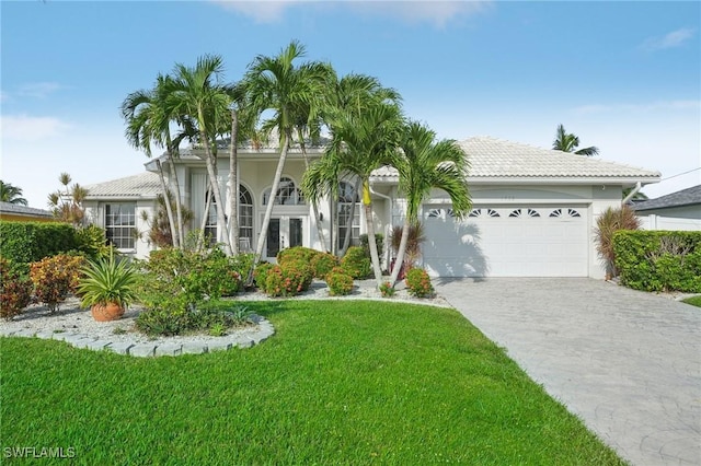 view of front of property with a garage and a front lawn