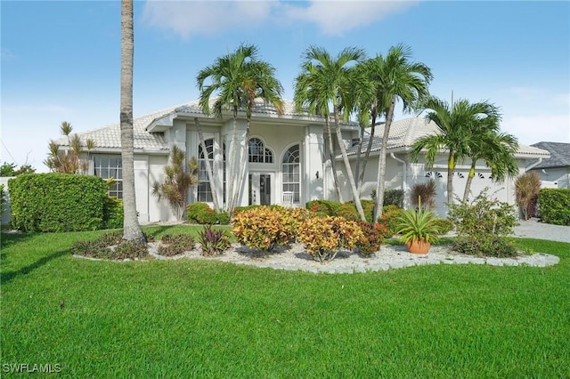 view of front of house with a front lawn and a garage