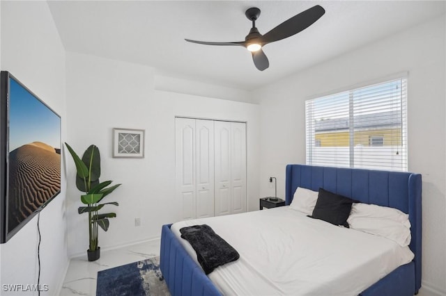 bedroom featuring ceiling fan and a closet