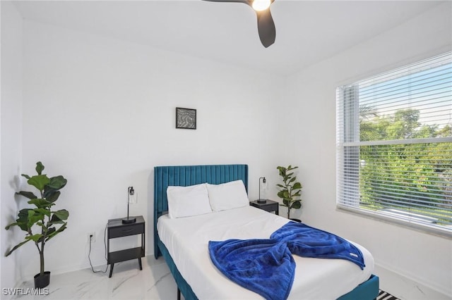 bedroom featuring multiple windows and ceiling fan