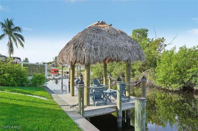 view of dock with a water view, a gazebo, and a lawn